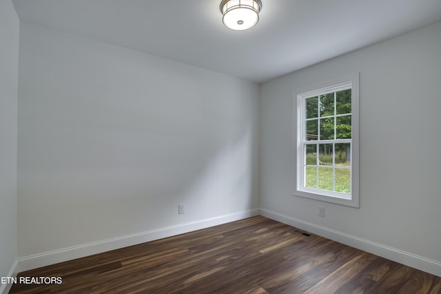 unfurnished room featuring dark hardwood / wood-style flooring