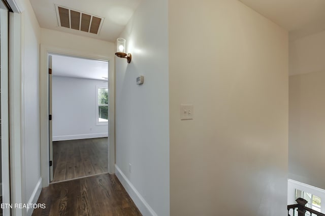 corridor with dark hardwood / wood-style flooring