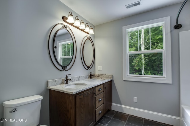 bathroom featuring toilet and vanity