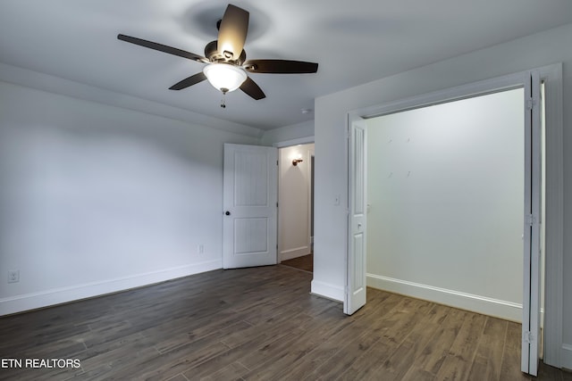 unfurnished bedroom featuring ceiling fan and dark wood-type flooring