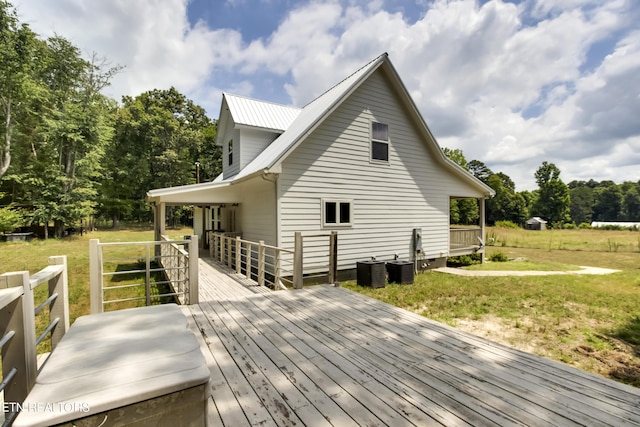 exterior space featuring a deck and a lawn