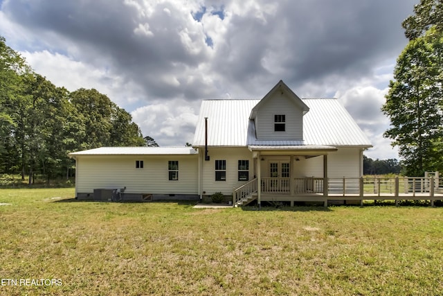 back of house featuring a lawn, central AC unit, and a deck