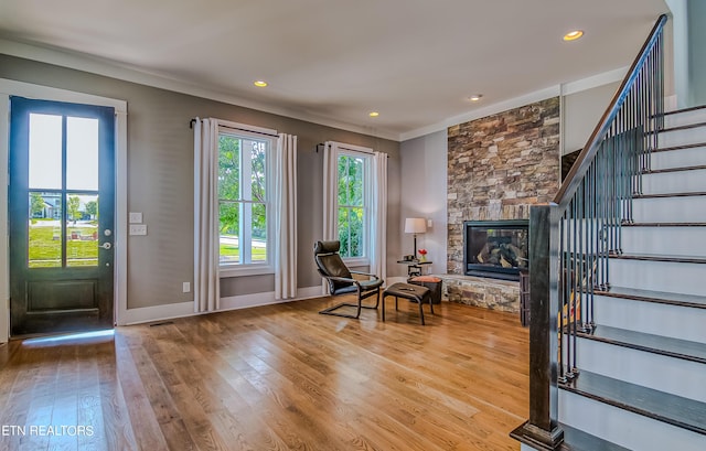 unfurnished room featuring hardwood / wood-style floors, crown molding, and a fireplace