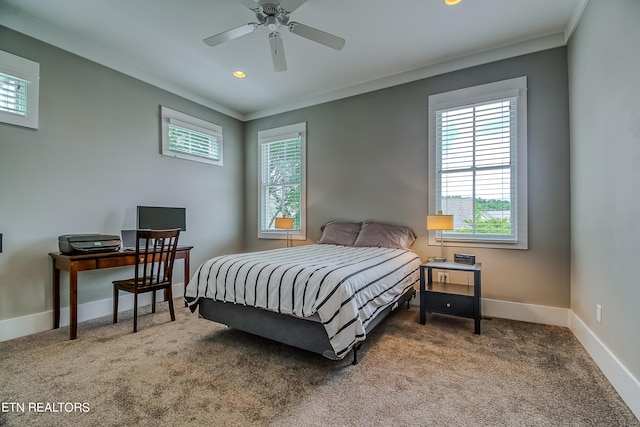 carpeted bedroom with ceiling fan and crown molding