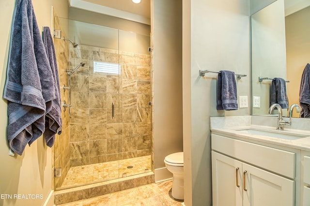 bathroom with vanity, a shower with shower door, and toilet