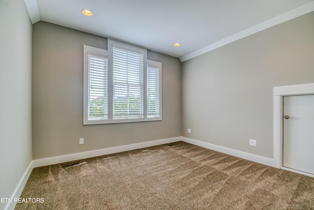 unfurnished room with vaulted ceiling and carpet flooring