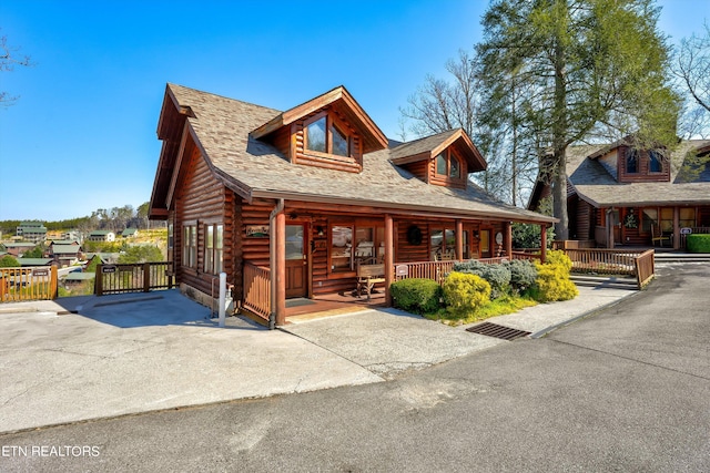 log cabin featuring a porch