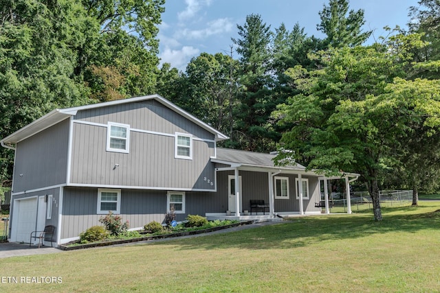 split level home with a front yard, a porch, and a garage