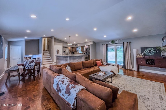 living room featuring dark hardwood / wood-style flooring and lofted ceiling