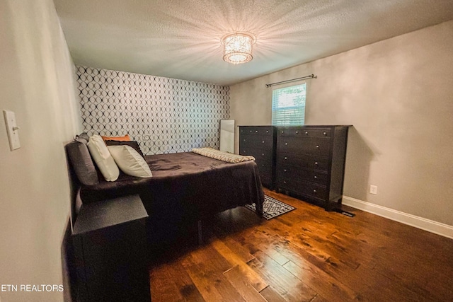 bedroom with dark hardwood / wood-style floors