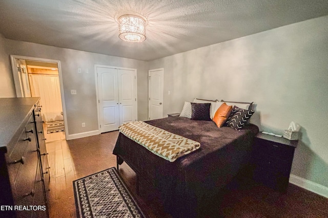 bedroom featuring a closet and dark hardwood / wood-style flooring