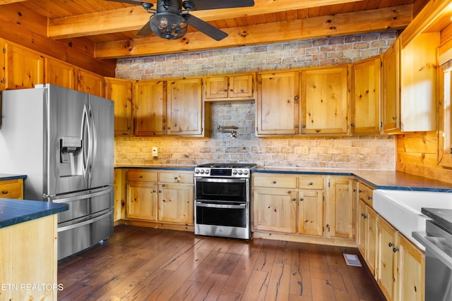 kitchen featuring beamed ceiling, dark hardwood / wood-style floors, ceiling fan, and appliances with stainless steel finishes