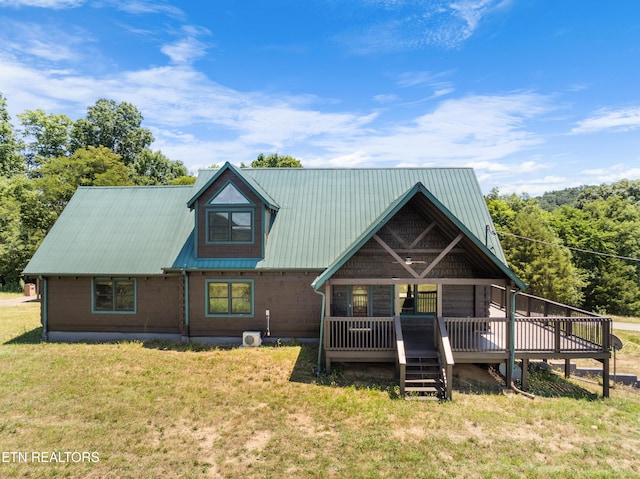 back of house featuring a wooden deck and a yard