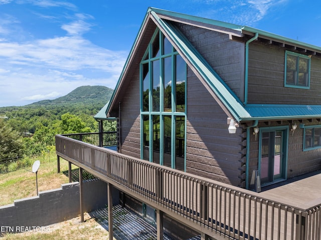 back of house with a deck with mountain view and a balcony