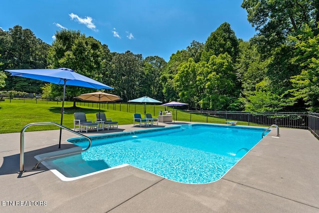 view of pool with a yard and a patio