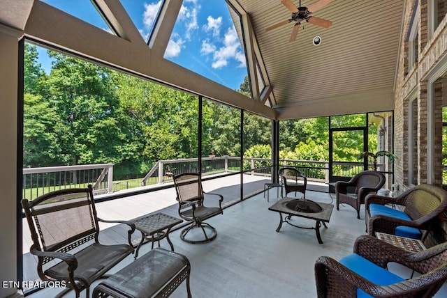 sunroom with vaulted ceiling, ceiling fan, and a wealth of natural light