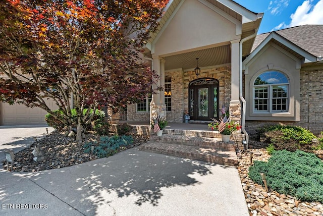 property entrance featuring a garage and a porch