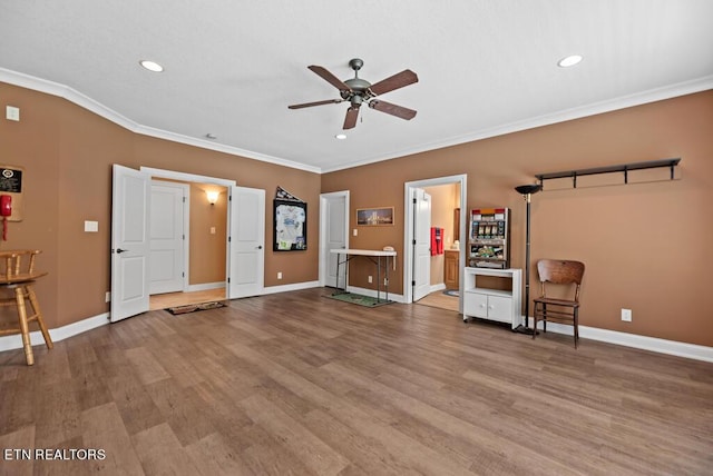 interior space featuring ceiling fan, light hardwood / wood-style flooring, and crown molding