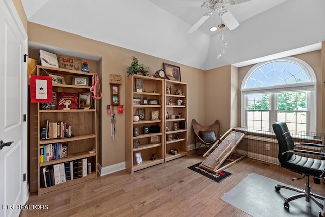 office with ceiling fan, vaulted ceiling, and light hardwood / wood-style floors