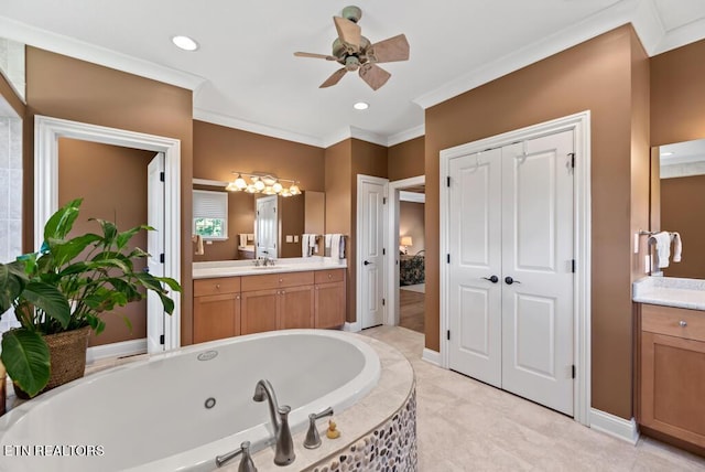 bathroom featuring ceiling fan, tiled tub, vanity, and crown molding