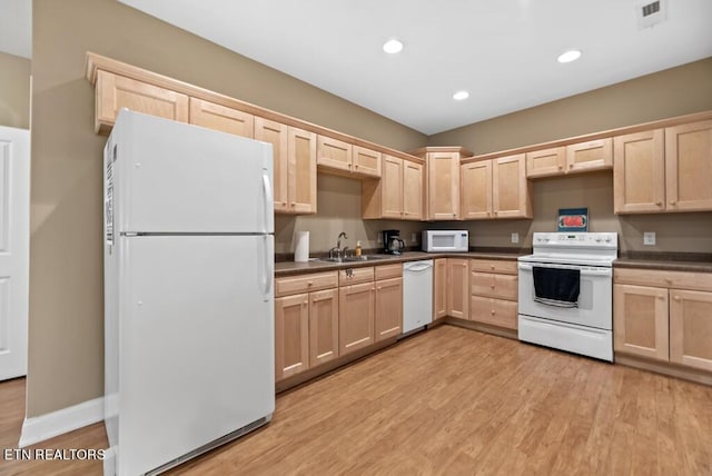 kitchen featuring sink, light hardwood / wood-style floors, light brown cabinets, and white appliances