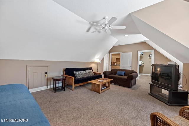 carpeted living room featuring ceiling fan and vaulted ceiling