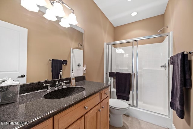 bathroom with tile patterned flooring, toilet, a shower with door, and vanity