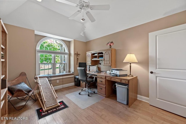 office area with light hardwood / wood-style floors, ceiling fan, and vaulted ceiling