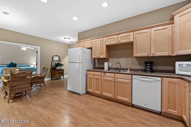 kitchen featuring light brown cabinetry, sink, white appliances, and light hardwood / wood-style flooring