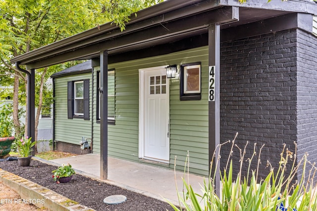 doorway to property with a porch