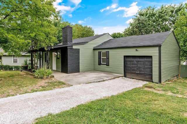 ranch-style house featuring a garage and a front lawn