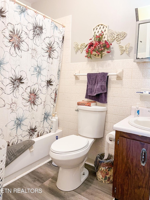 full bathroom with toilet, tile walls, hardwood / wood-style floors, and vanity