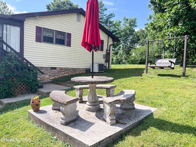 view of yard with central air condition unit and a patio