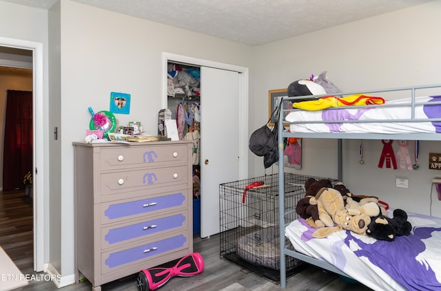 bedroom featuring a textured ceiling, a closet, and hardwood / wood-style flooring