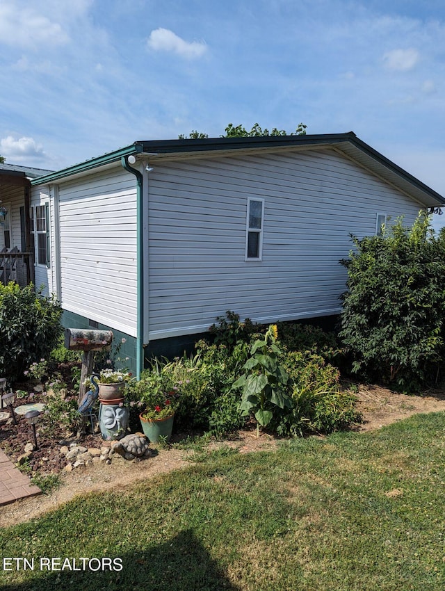 view of home's exterior with a yard