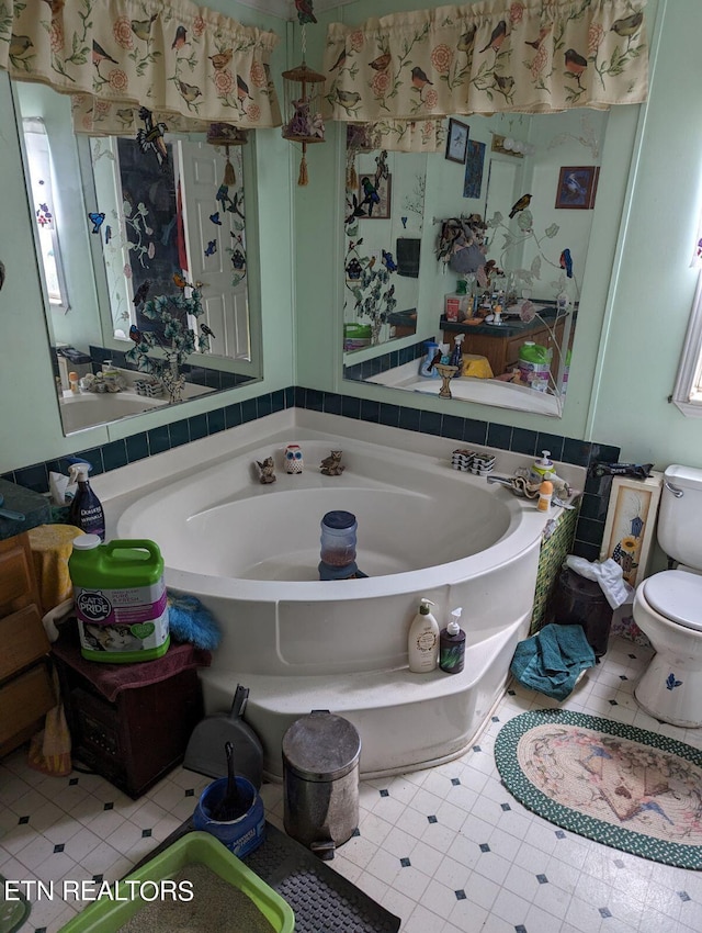 full bathroom with toilet and a bath