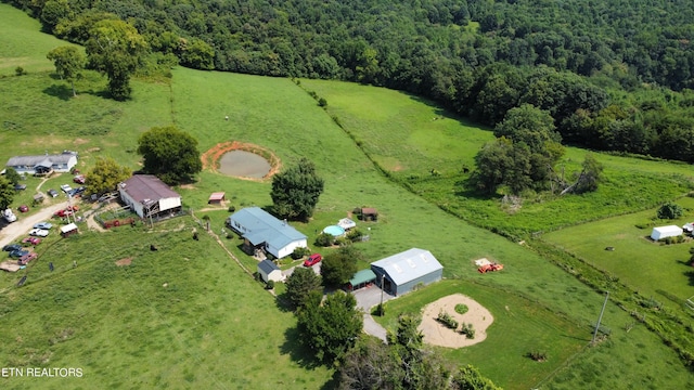 drone / aerial view with a forest view and a rural view