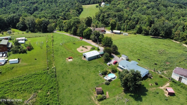 drone / aerial view featuring a wooded view and a rural view