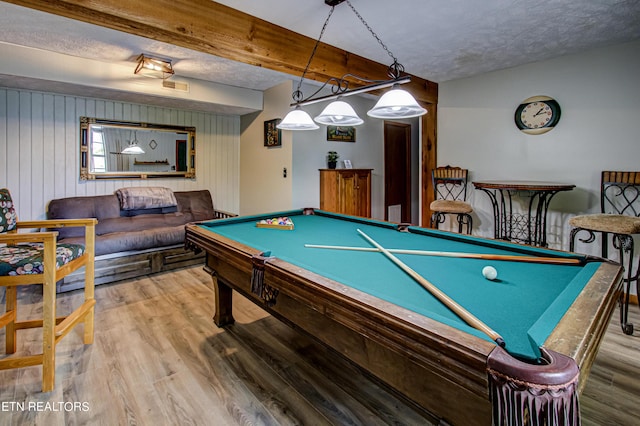 recreation room with a textured ceiling, wood-type flooring, beamed ceiling, wooden walls, and billiards