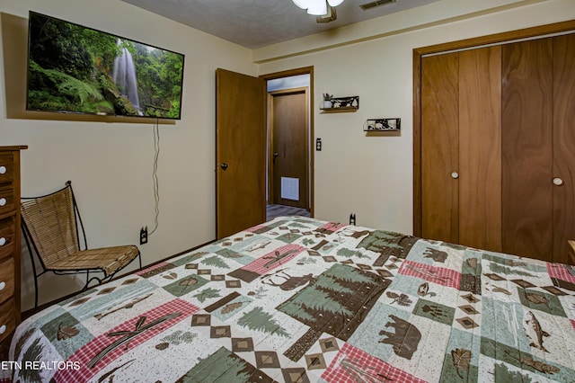 bedroom with a textured ceiling and a closet