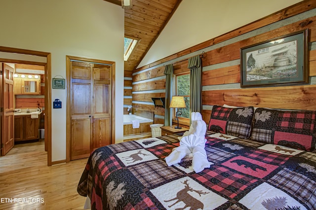 bedroom with lofted ceiling, wood walls, light hardwood / wood-style floors, a closet, and wooden ceiling