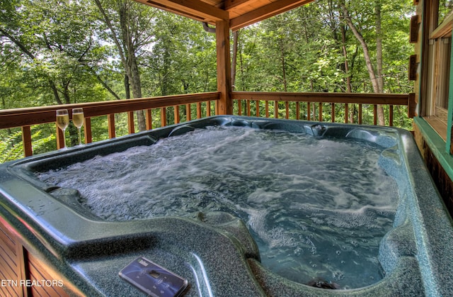 wooden terrace with a hot tub