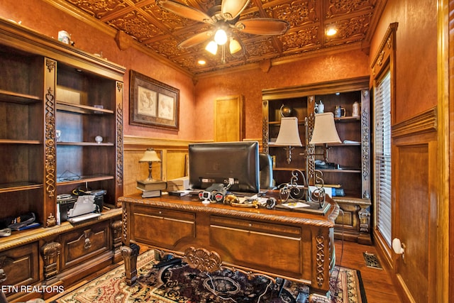 office space featuring wood-type flooring, crown molding, coffered ceiling, and ceiling fan