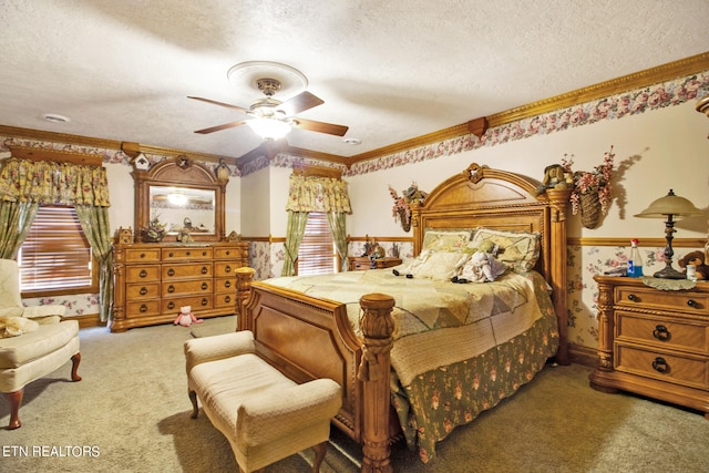 carpeted bedroom with multiple windows, a textured ceiling, and ceiling fan