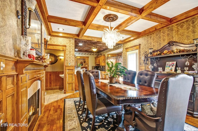 dining area with beamed ceiling, hardwood / wood-style flooring, and coffered ceiling