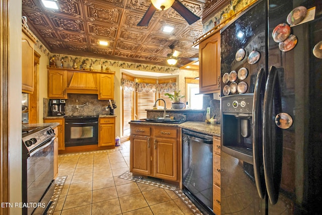 kitchen featuring premium range hood, black appliances, ceiling fan, sink, and backsplash