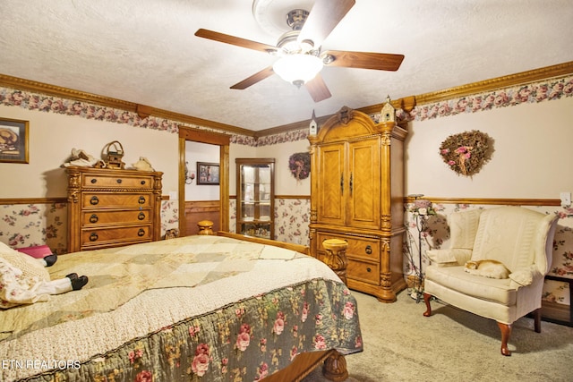 carpeted bedroom featuring a textured ceiling and ceiling fan