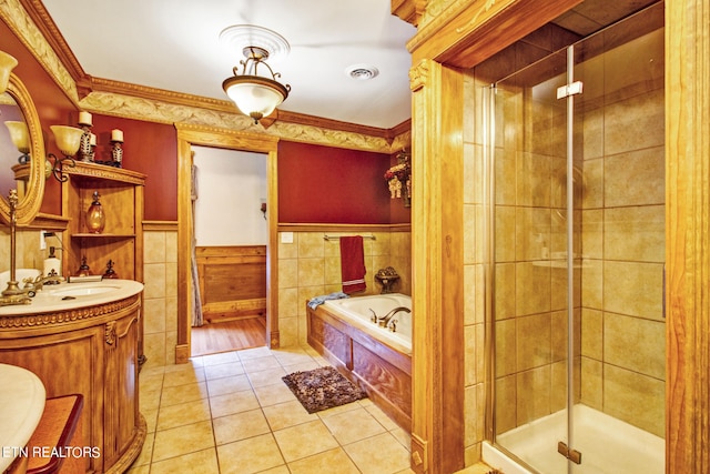 bathroom with vanity, tile walls, shower with separate bathtub, hardwood / wood-style flooring, and ornamental molding