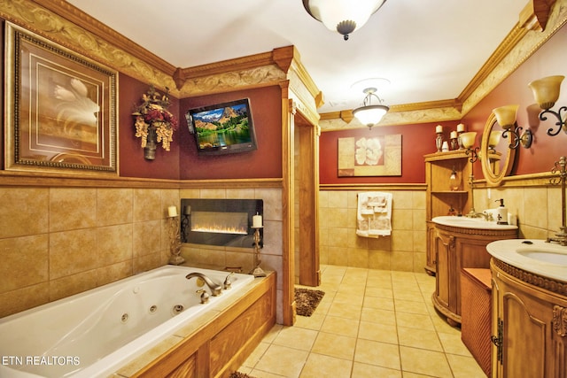 bathroom with tile walls, double vanity, crown molding, a tile fireplace, and tile patterned flooring