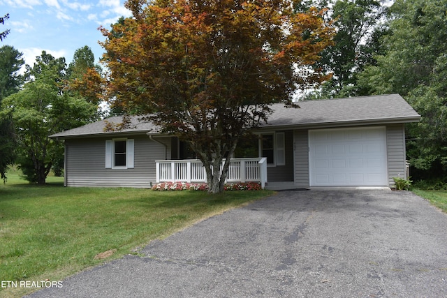 single story home with a garage, a front lawn, and covered porch